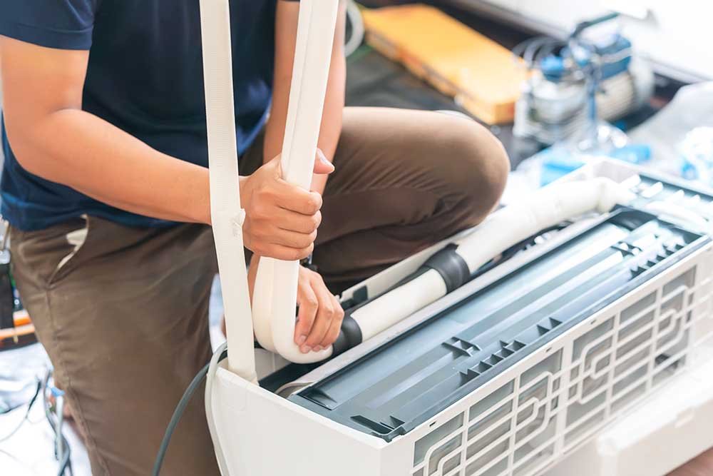 Technician man install new air conditioner, Repairman service for repair and maintenance of air conditioners